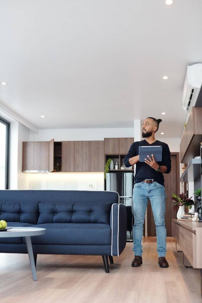 man-using-smart-house-app-682x1024