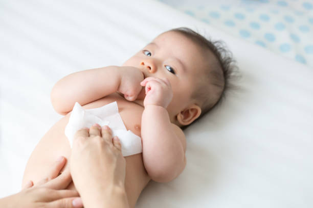 Baby Wipes 66 - Mom cleaning up and wipe body baby by wet tissue when changing nappies or diaper and wiping the hands or face or leg, Personal hygiene for mother and Toddler kid with wet wipes paper concept